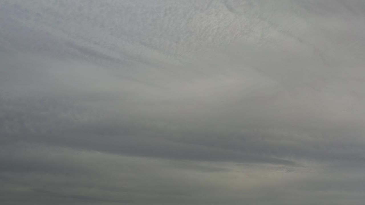 Layered gray clouds fill the frame over Los Cabos, Mexico, with soft diffuse light and no visible people.