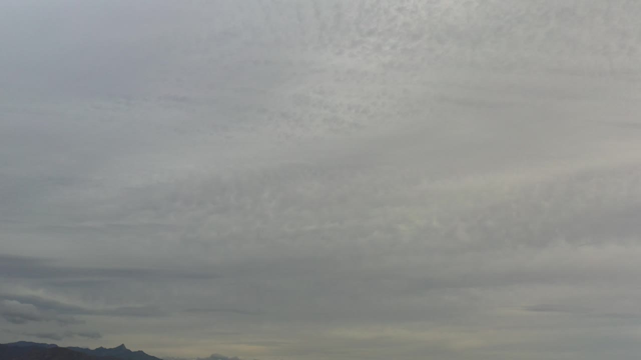 Gray overcast sky above a distant mountain horizon.