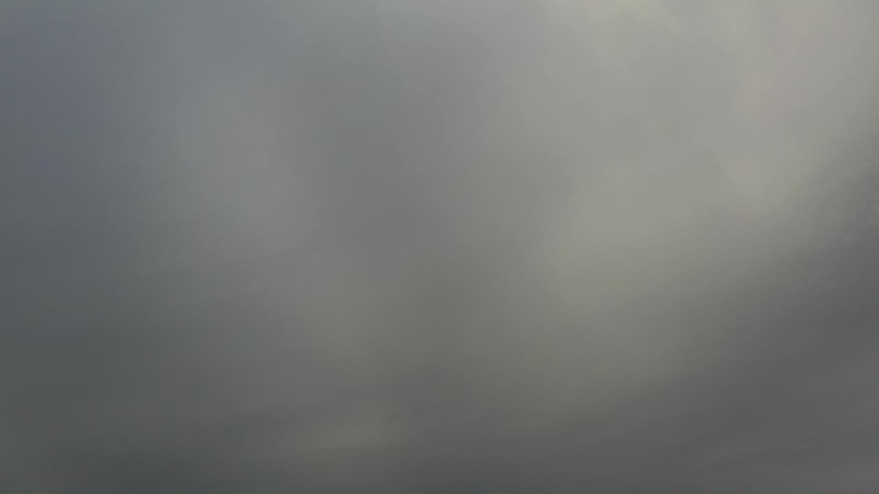 At 0:01, the unfocused Los Cabos footage shows muted gray blur with a slightly darker lower band and no visible people.