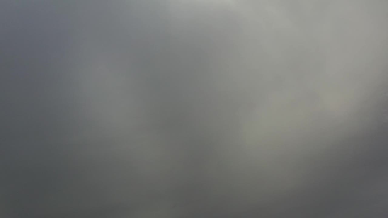 Los Cabos overcast sky with broad gray cloud layers and a brighter white area near the upper right, no visible people.