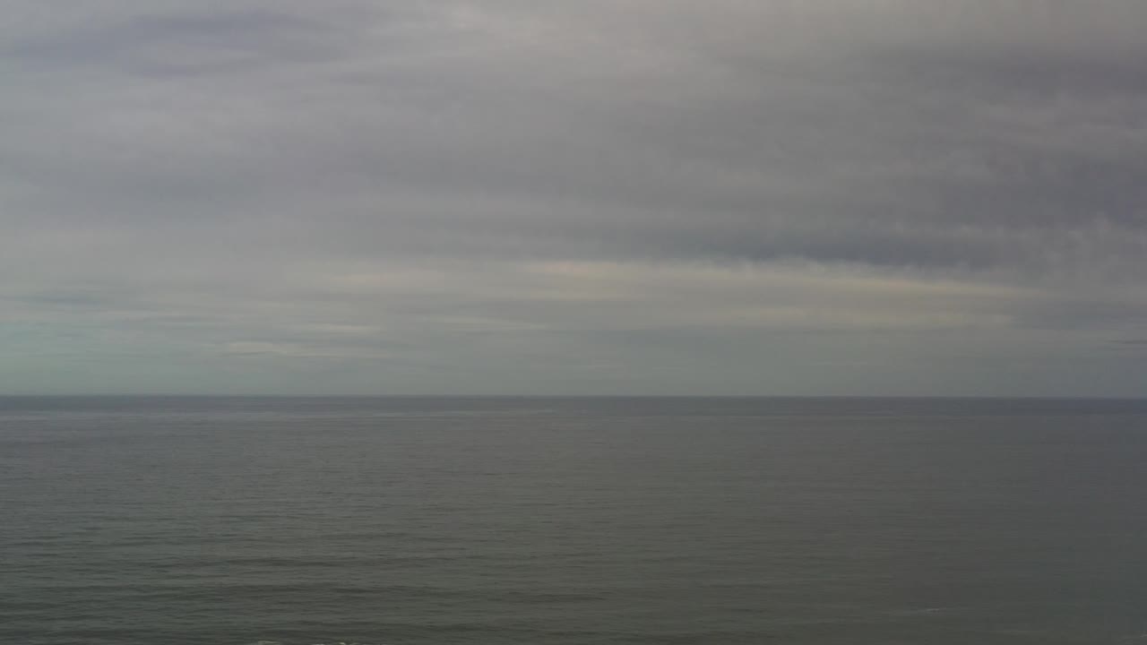 Distant ocean surface and overcast sky.