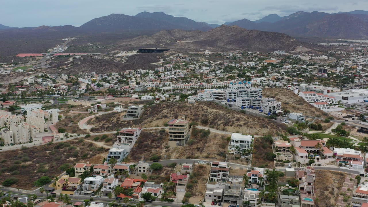 Aerial view of hillside homes, roads, and mountains