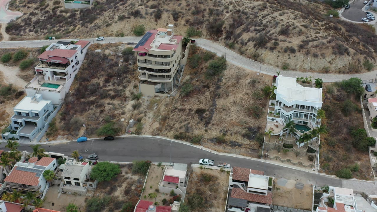 Aerial view of houses along a sloped road