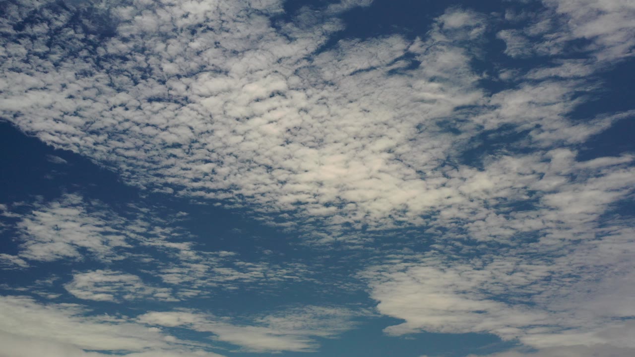 Blue sky filled with scattered white clouds.