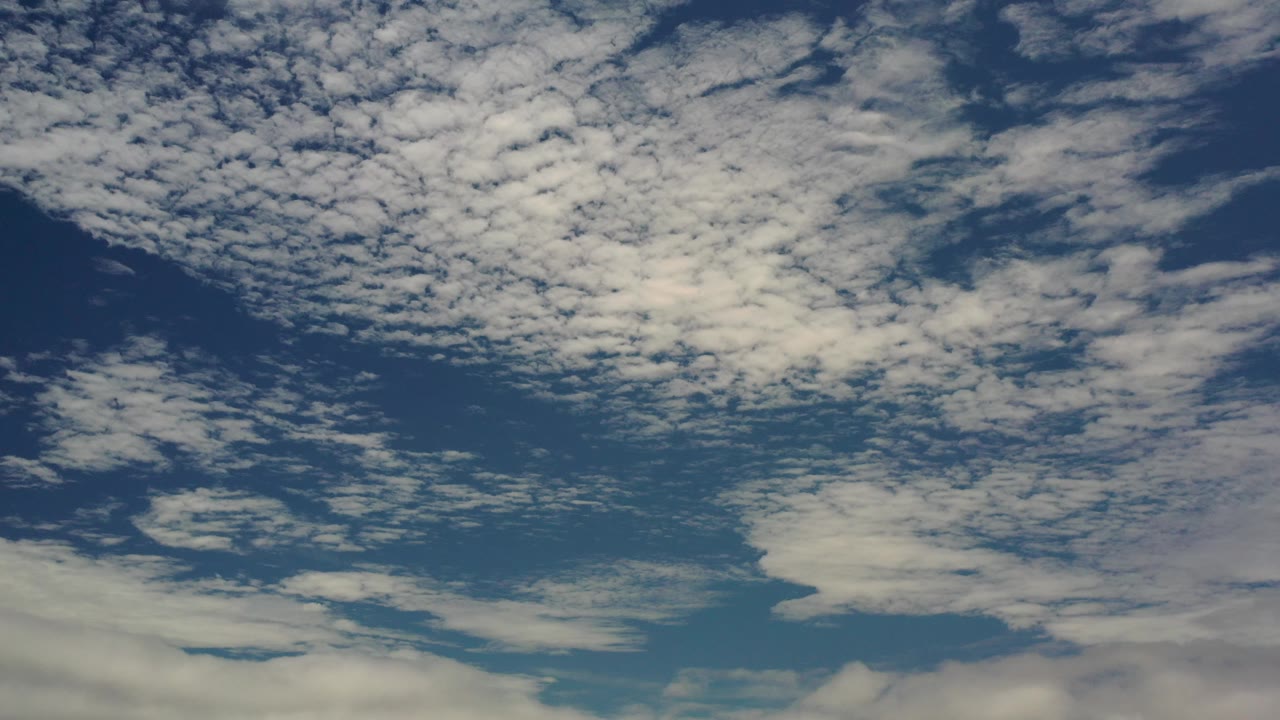 Layered clouds over blue sky.