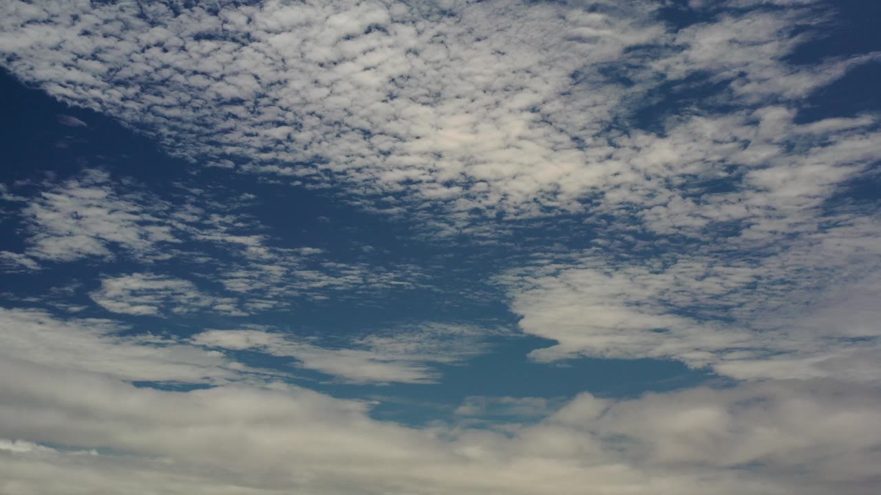 Cloud bands cross a blue sky with muted evening or morning light.