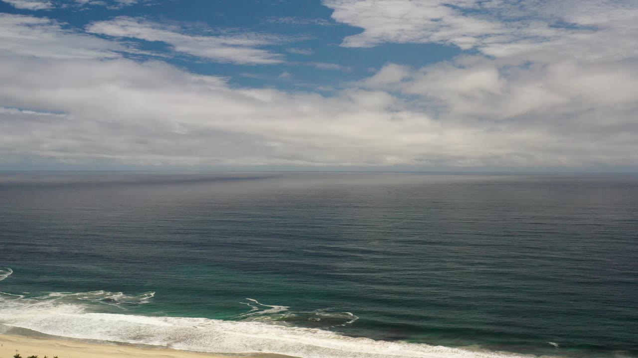 Aerial coastline view with surf patterns near sandy beach