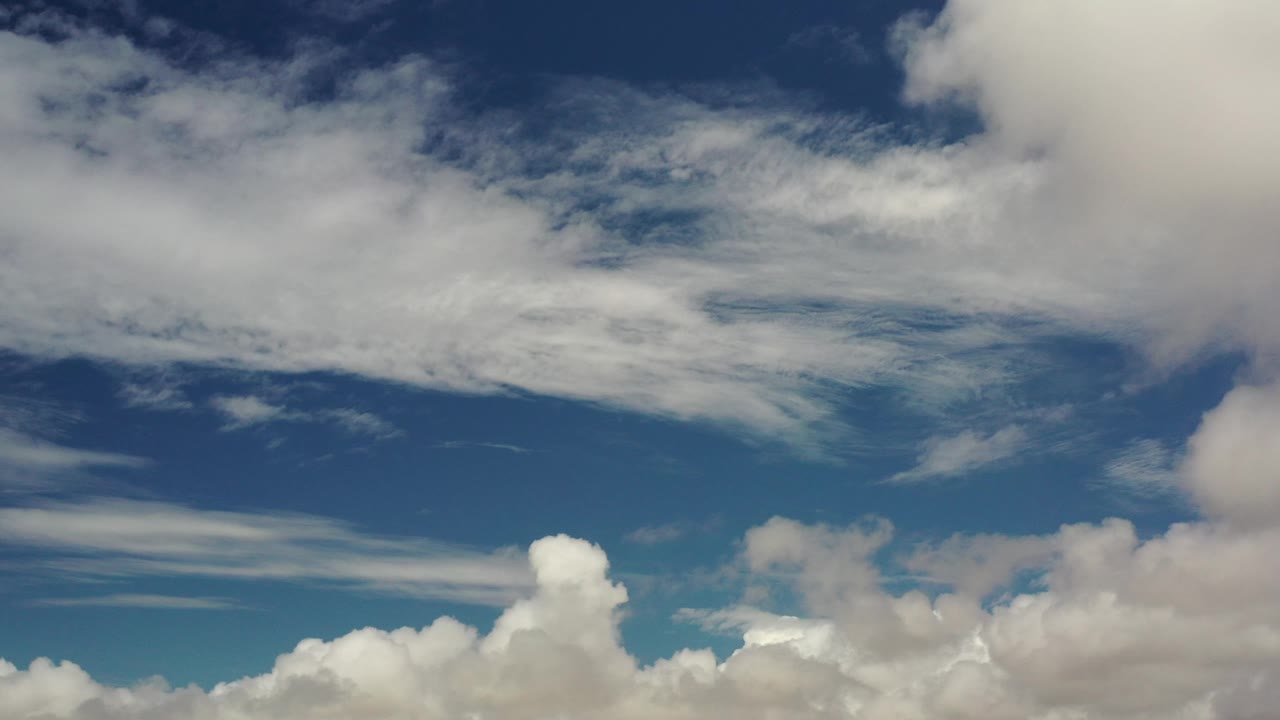White cloud bank spread across a dark blue sky.