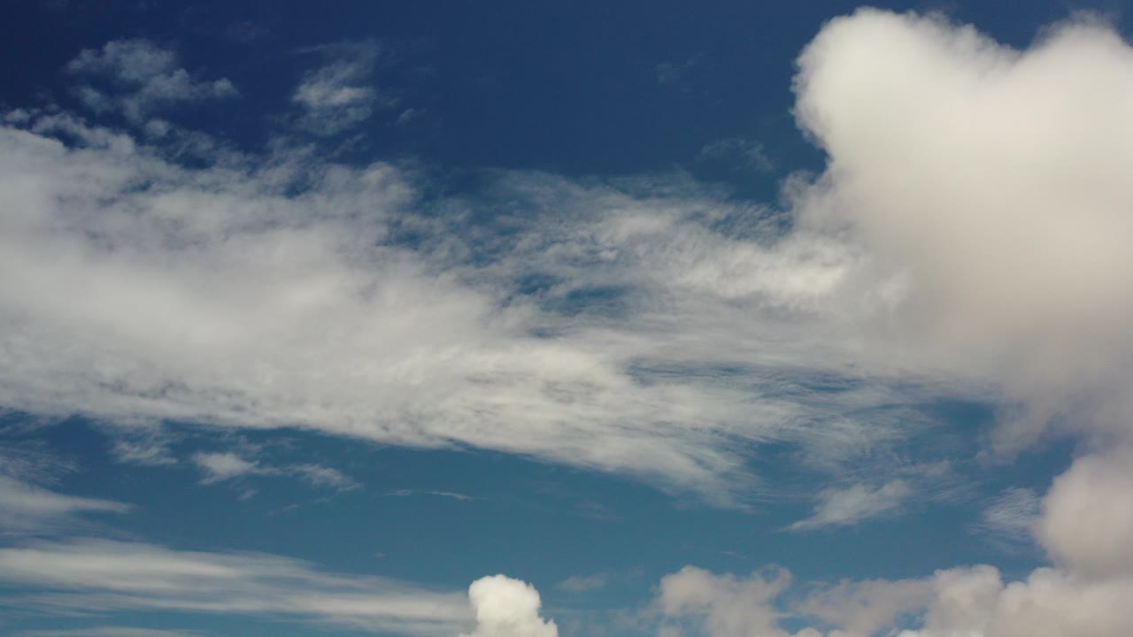 Blue sky over Los Cabos, Mexico, with a broad band of white clouds through the middle and no visible people.