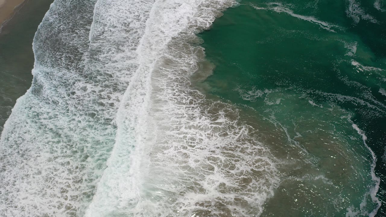 Overhead surf line crossing green ocean water