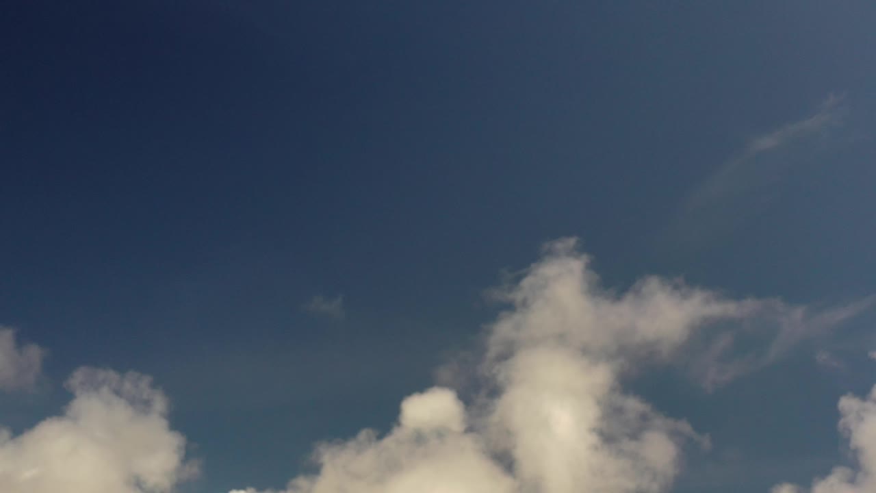 Tall white cloud shape against blue sky.