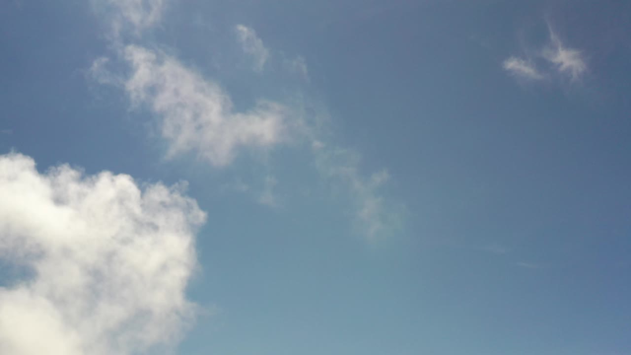 Small wispy clouds over a blue sky.