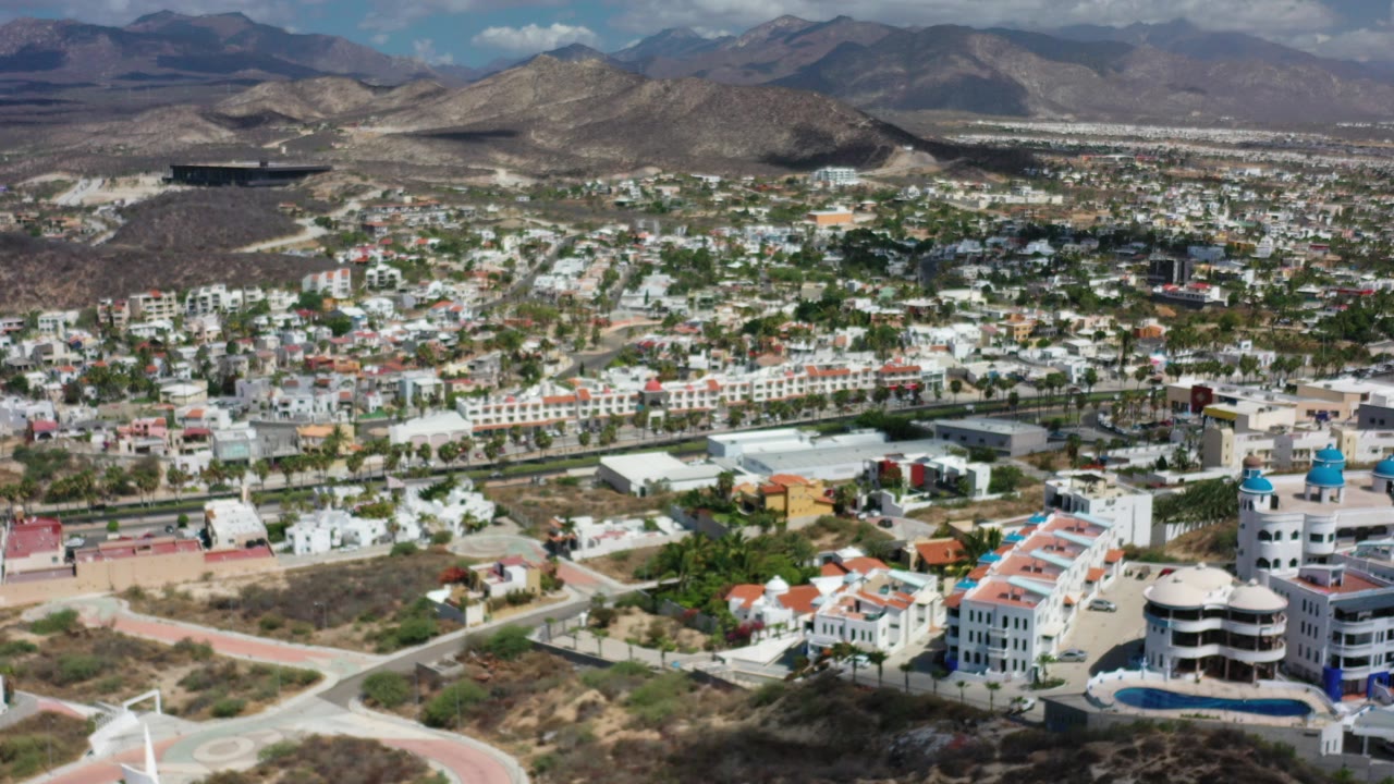 Aerial view of a city below desert mountains