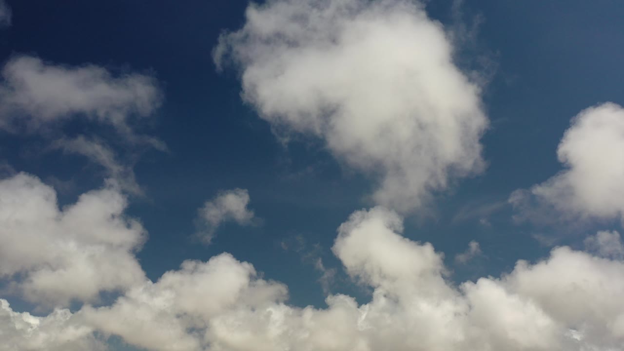 White clouds against a deep blue sky.