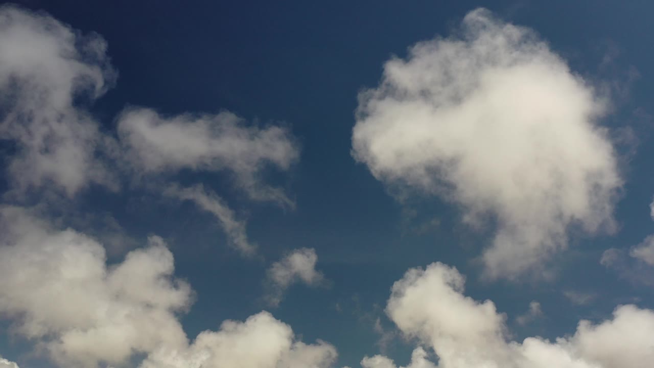 White cloud cluster filling the upper right over blue sky.