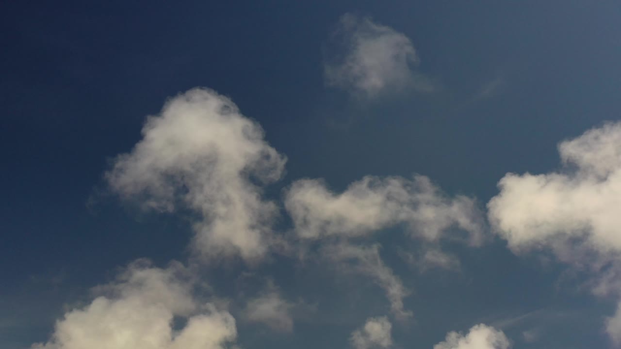 White clouds drifting in open blue sky