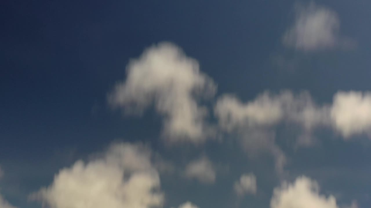 At 0:01, a rounded white cloud cluster sits near the upper center of the Los Cabos sky, with no visible people or structures.