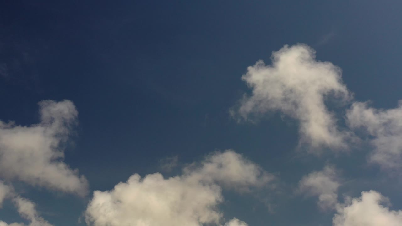 Large pale cloud forms near the top of a blue sky.