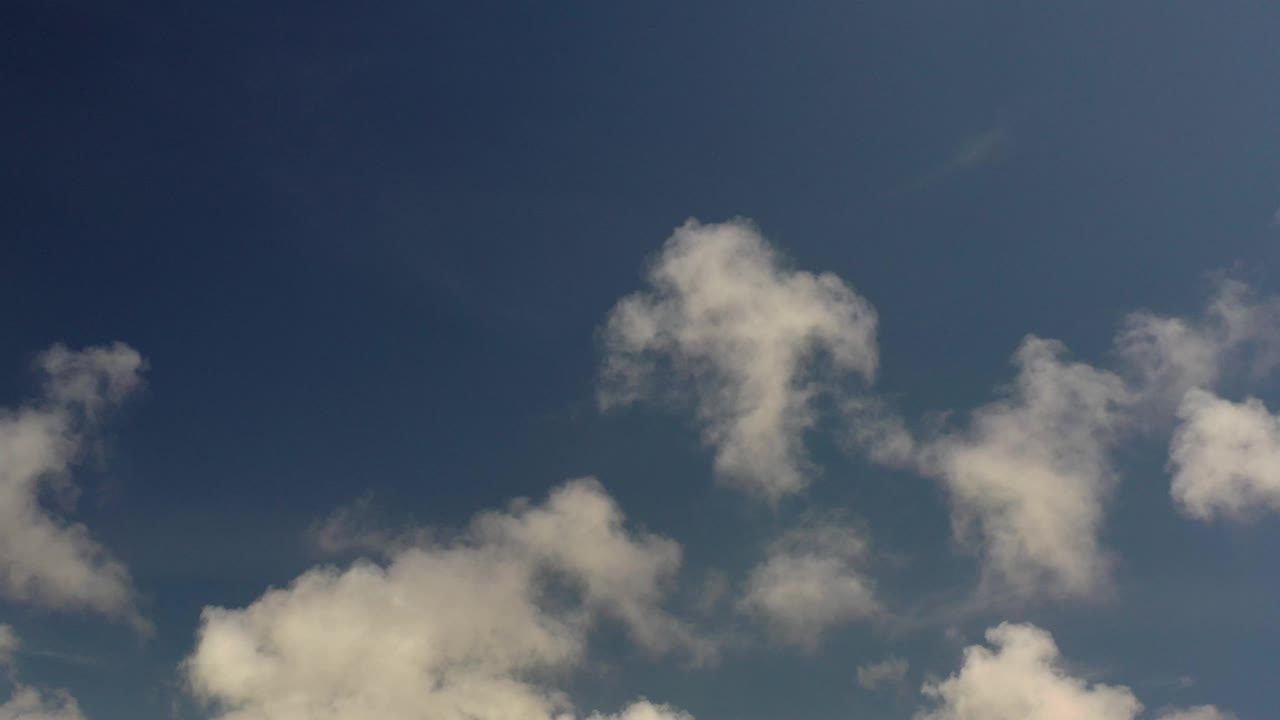 White cloud clusters under blue sky.