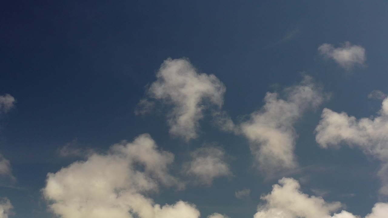 Opening frame of Los Cabos cloud cover against a deep blue sky, with no visible people or ground features.