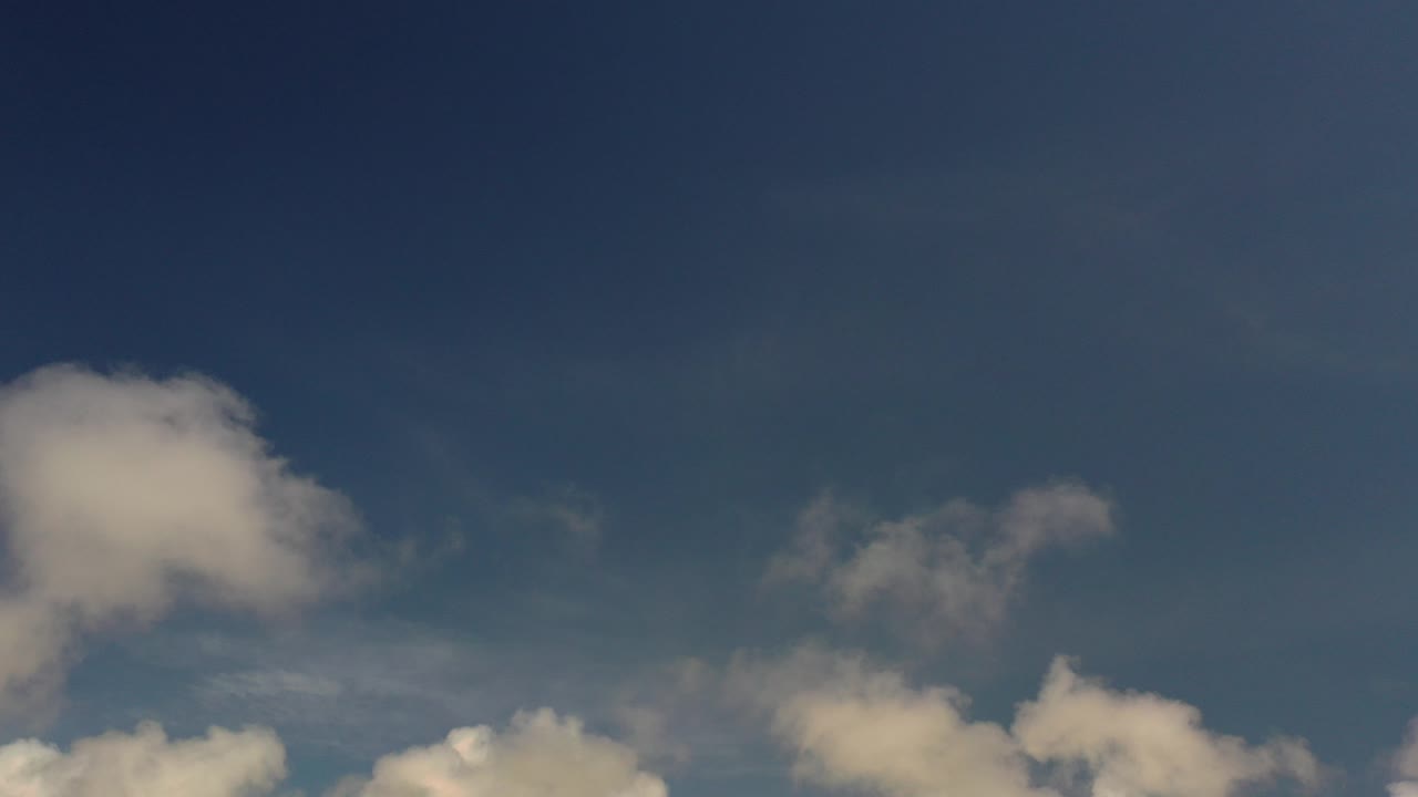 Blue sky with gray and white clouds along the lower edge.