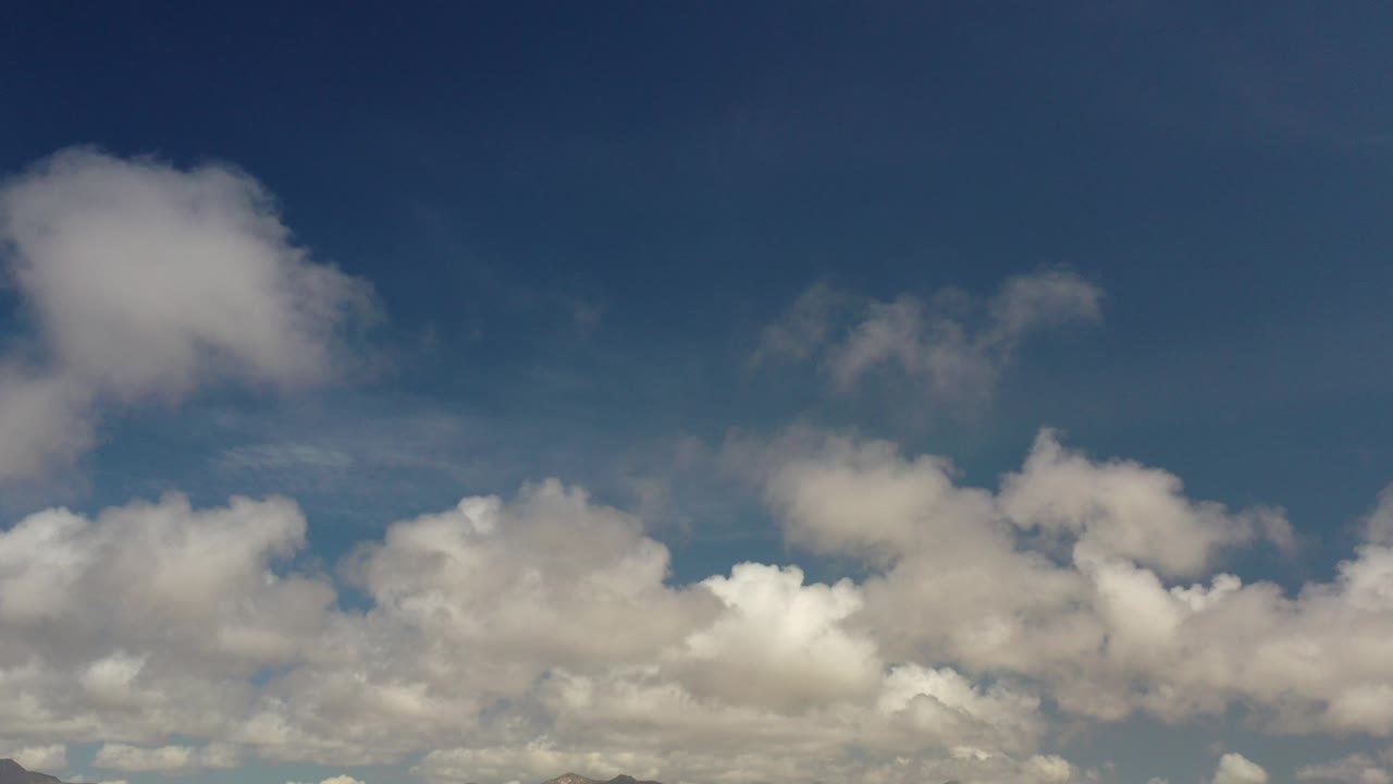 Cloudy blue sky over distant mountains