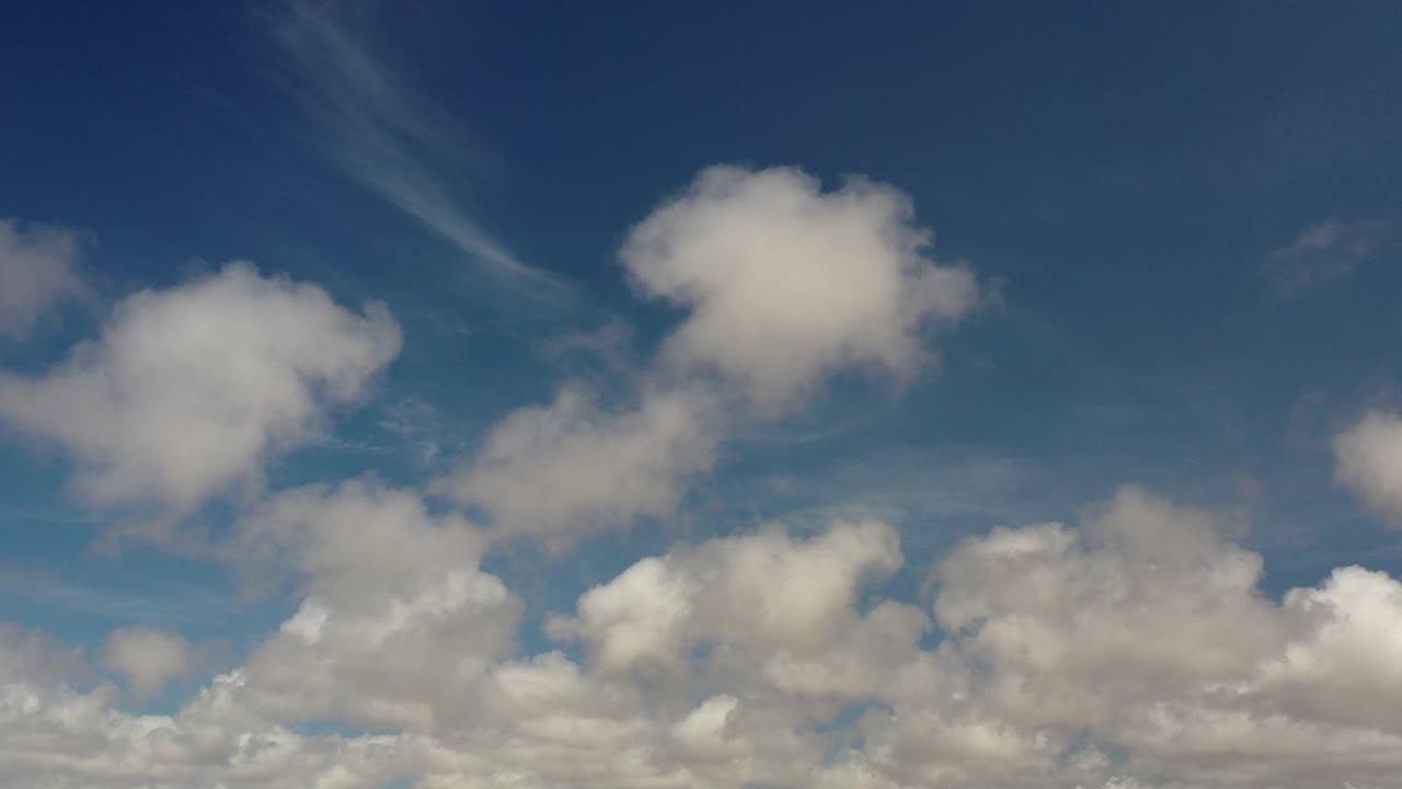 Blue sky over Los Cabos, Mexico with puffy white clouds across the lower half and no visible people.