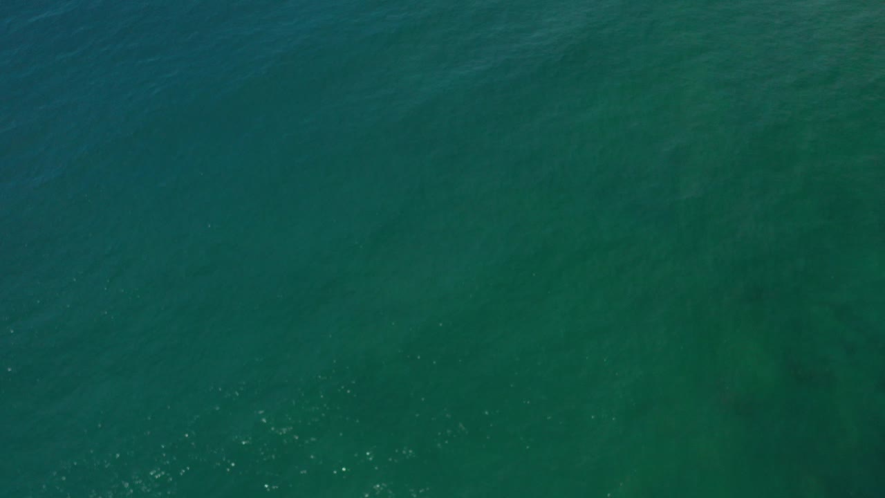 Overhead aquamarine ocean water with small ripples