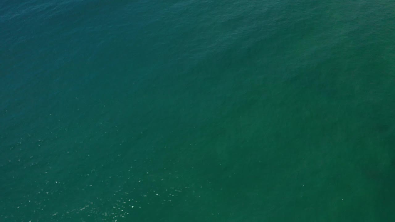 Dark teal sea surface with gentle wave texture