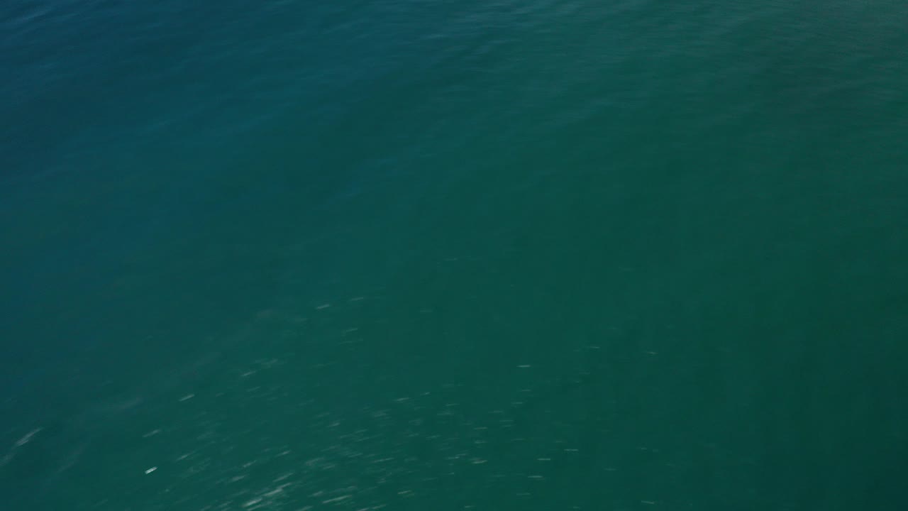 High-angle view of dark teal ocean water in Los Cabos, Mexico, with subtle ripples and no visible people.