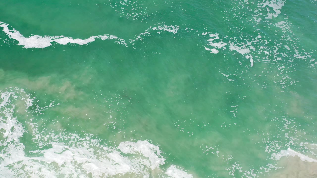 Breaking surf and green water seen from directly above.