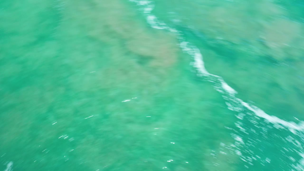 Turquoise sea with pale underwater patches.
