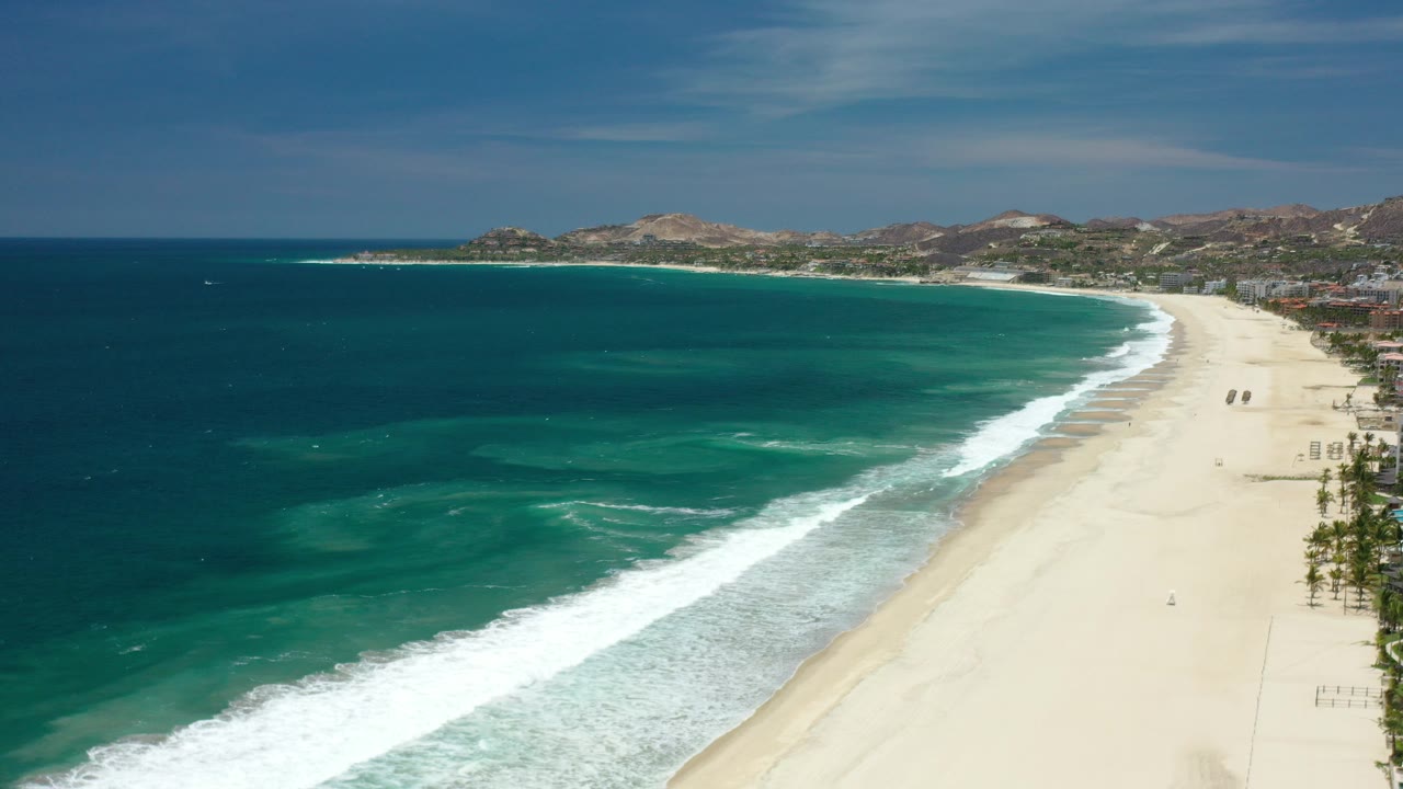 Aerial view of turquoise ocean and pale sand beach