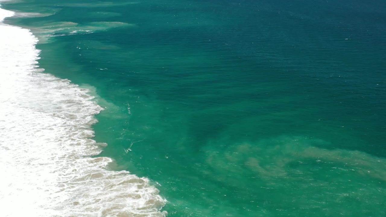 Green water with surf foam on the left