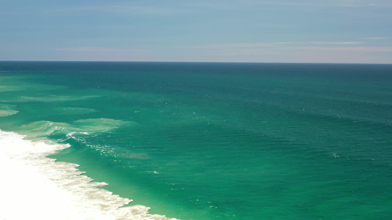 Open turquoise sea with pale surf near the lower left.