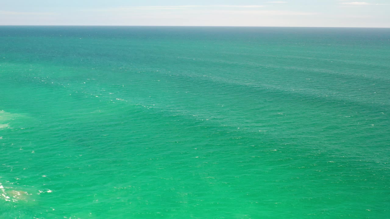 Wide turquoise ocean view with a straight horizon.