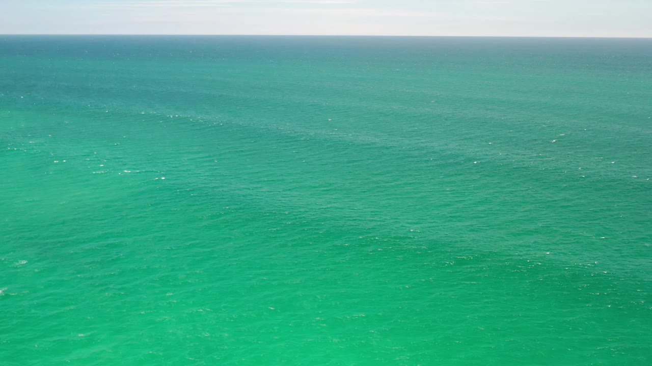 Wide view of open turquoise water in Los Cabos, Mexico, with the horizon held near the top of frame and no visible people.