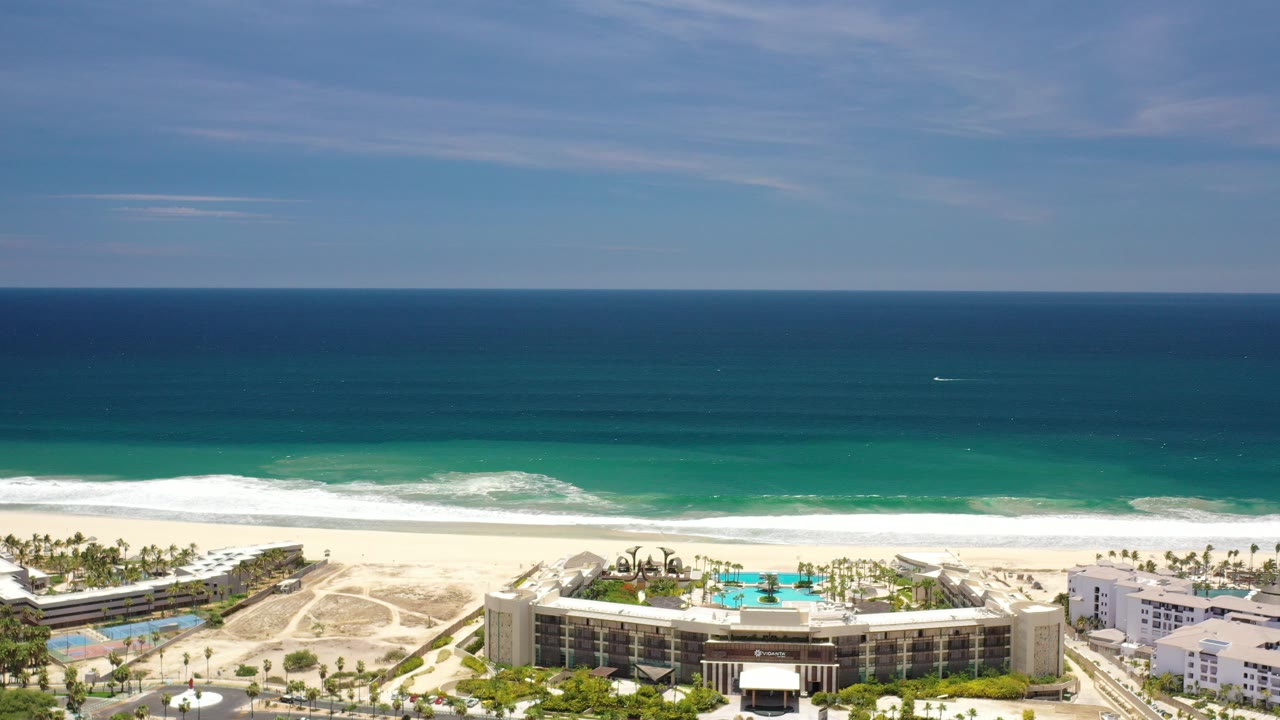 Wide aerial view of ocean, beach, and resort buildings