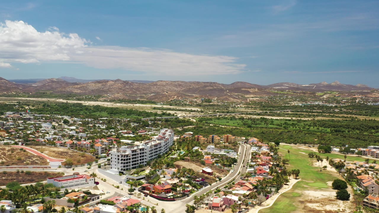 Aerial view of a coastal community with mountains and blue sky