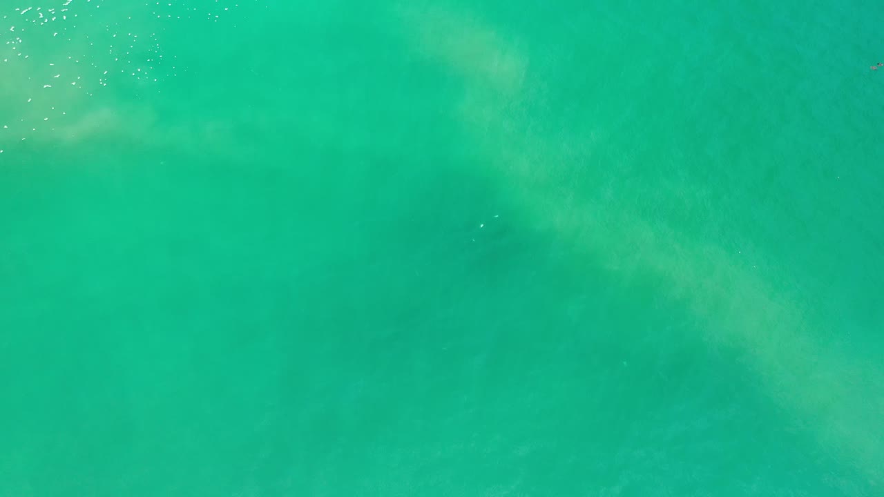 Turquoise green ocean water with pale underwater patches