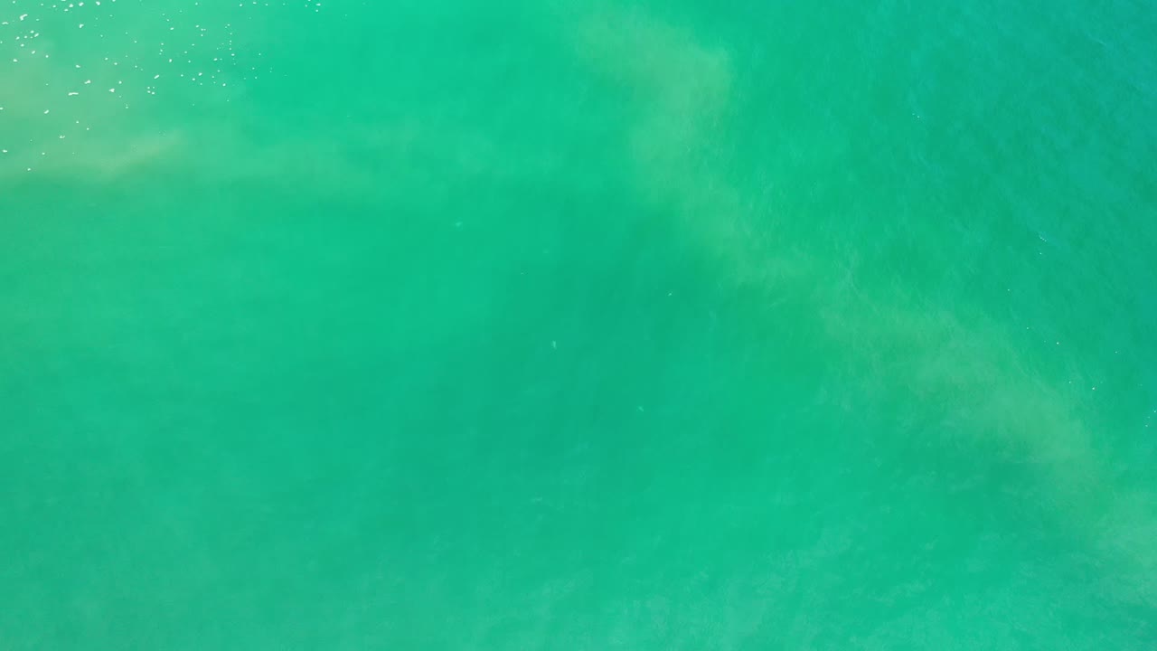 Overhead green ocean water with faint wave texture