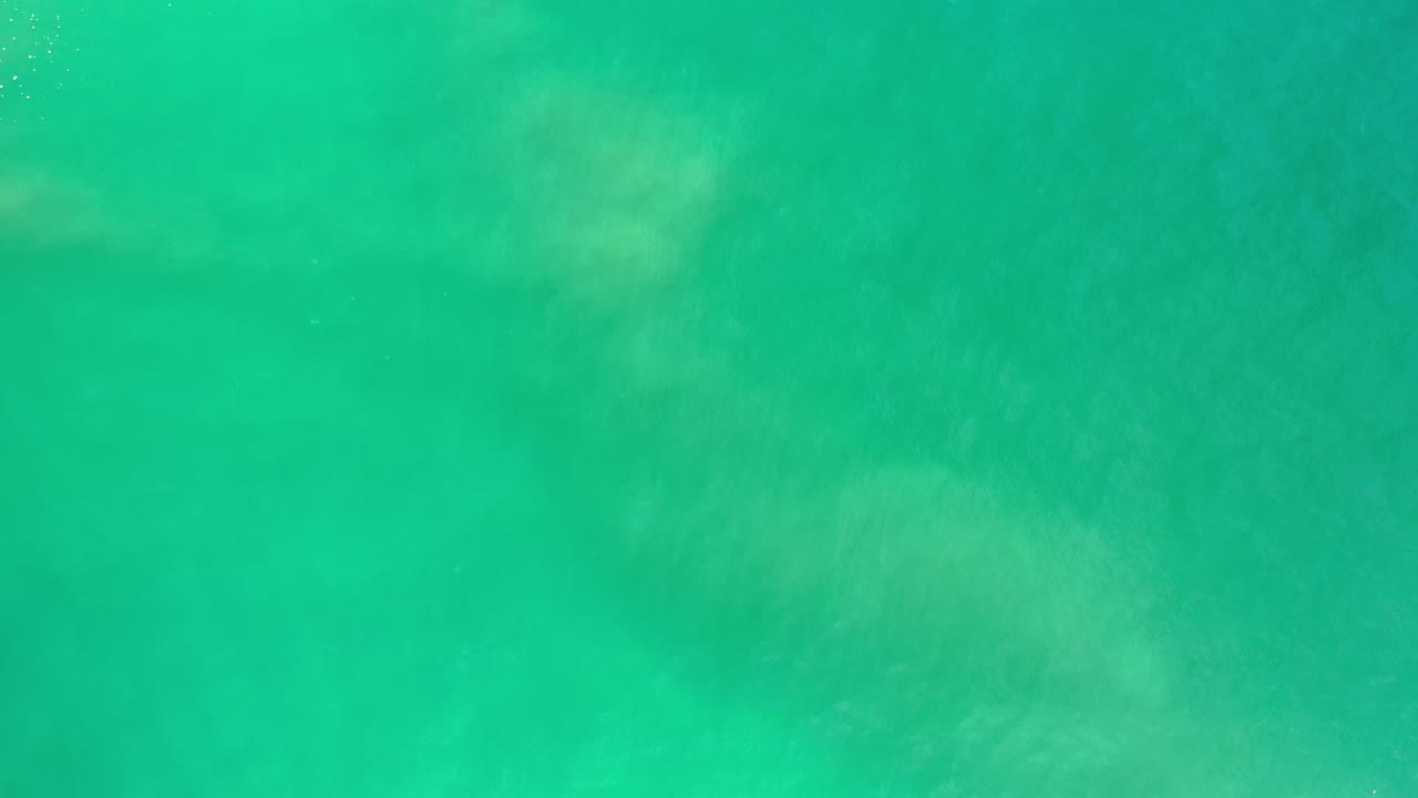 Turquoise ocean surface with soft underwater patches