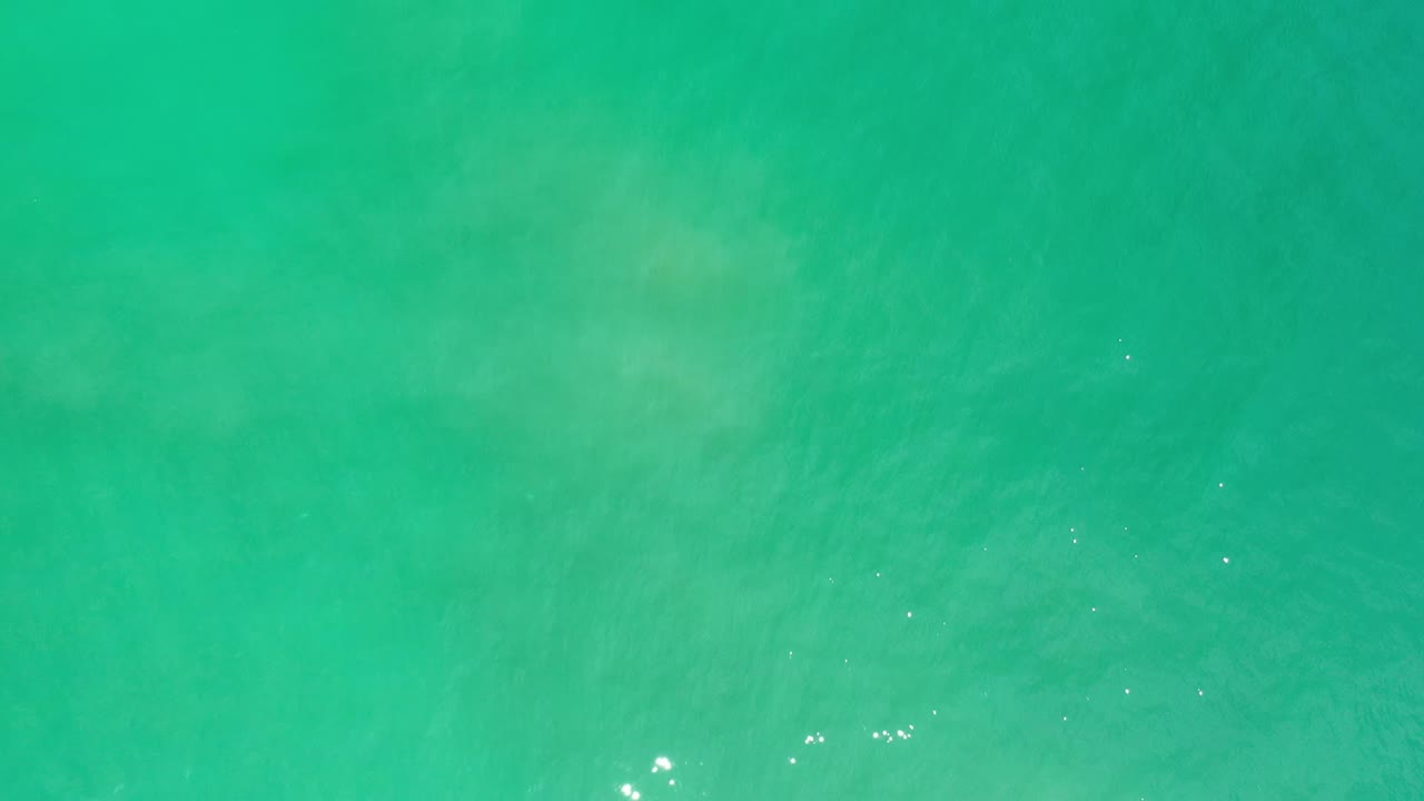 Turquoise ocean water viewed from directly above.