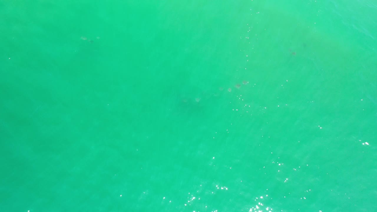 Aerial view of green ocean water with mild wave patterns.