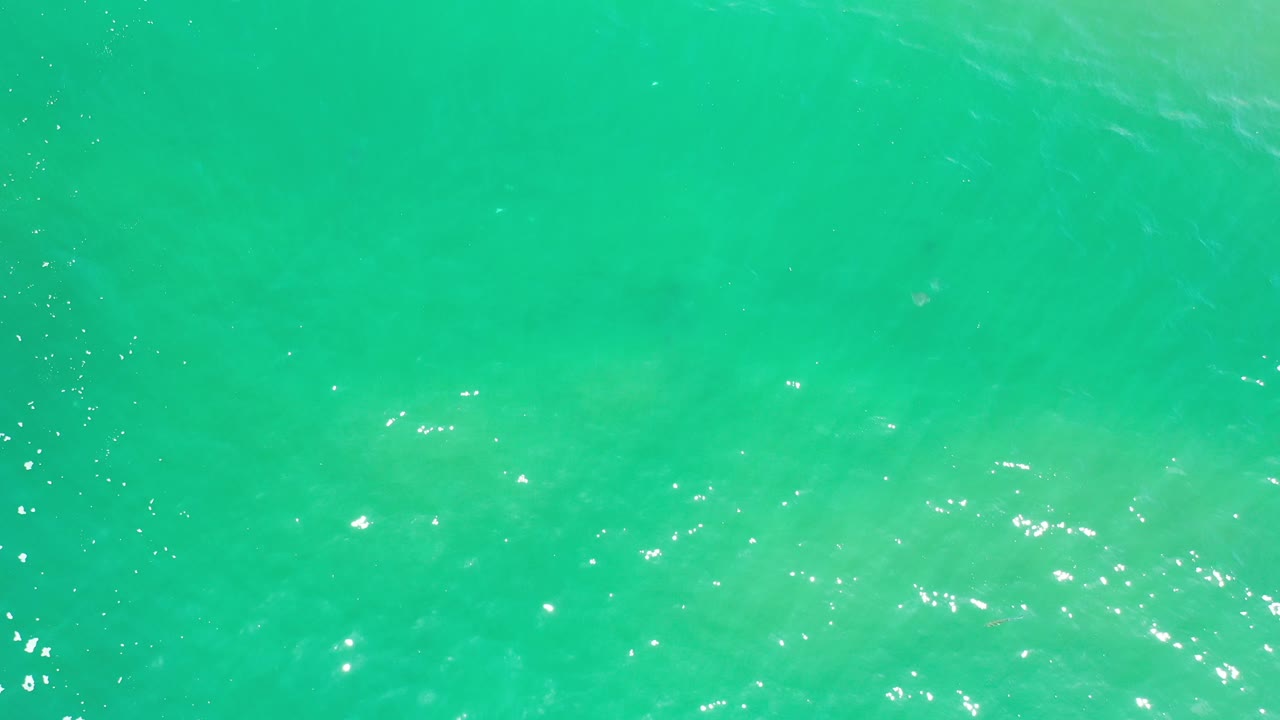 Open turquoise sea with stronger white reflections