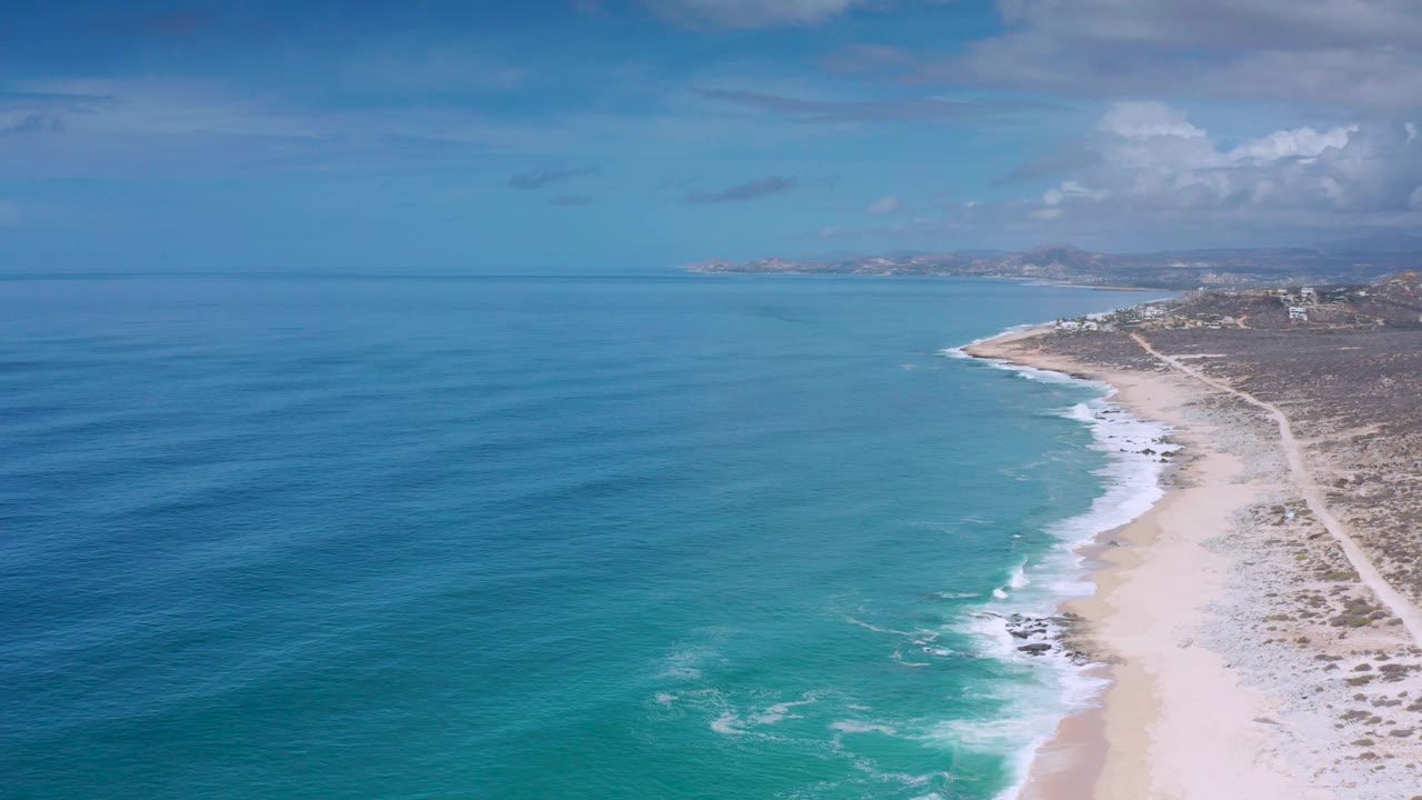 Aerial coastline with blue ocean and a narrow beach road