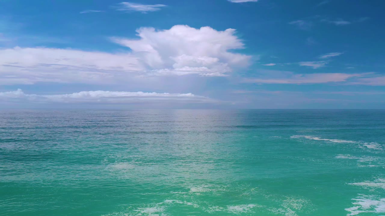 Los Cabos ocean view with soft wave texture across the water, a centered horizon, bright blue sky, and no visible people.