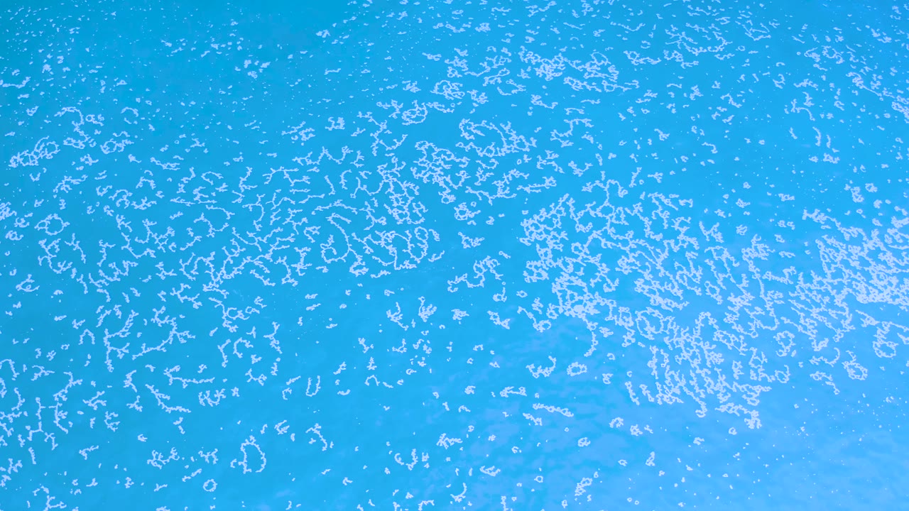 Blue water surface with fine white wave marks