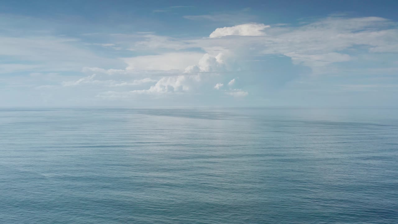 At 0:02, the frame shows blue water across the foreground, layered cloud forms in the distance, and no visible people or structures in Los Cabos, Mexico.