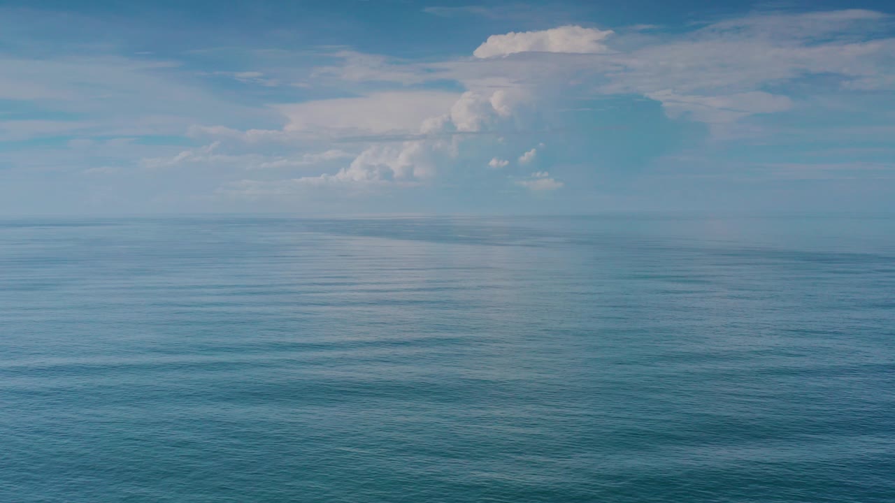 Wide blue ocean under a cloudy sky